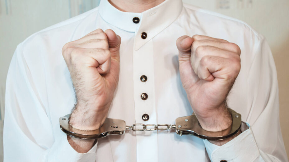 Young,Businessman,In,Handcuffs,Hand,Clenched,In,Fist