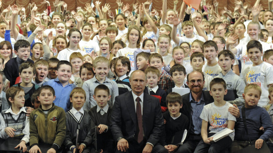 Russian President Putin poses for a picture with members of a children's choir during his visit to the Mariinsky Theatre in St.Petersburg