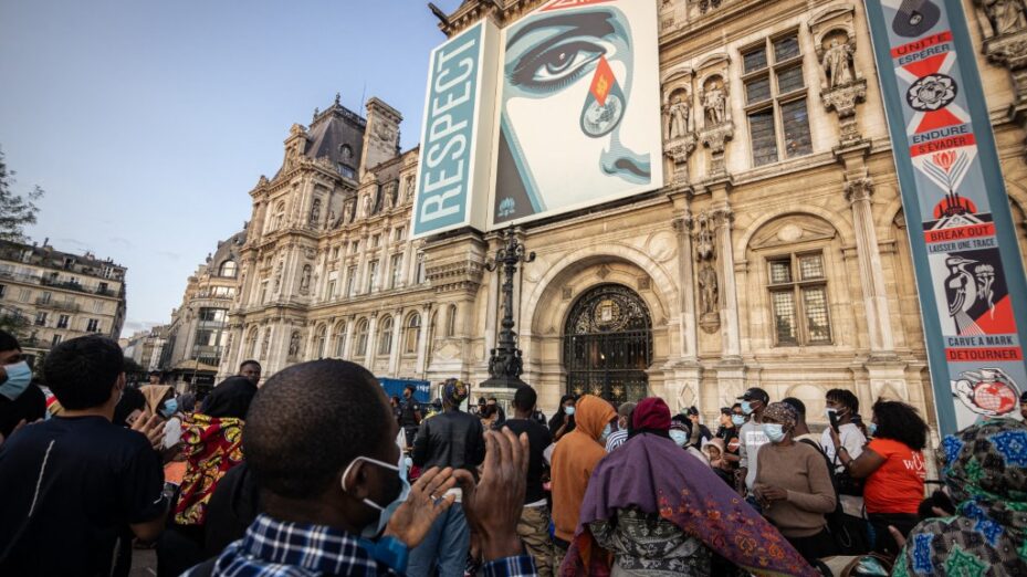 Around 200 homeless migrants, including 80 children, spend the night in front of the Hotel de Ville in Paris, France, on August 5, 2025, due to a lack of emergency accommodation. With the support of the Utopia 56 Association, the migrants, mostly women and children, gather in protest to demand housing solutions from the Paris City Hall and intend to remain in front of City Hall until concrete solutions are found. Several volunteers support the action by distributing sleeping bags, blankets, water, and some food. (Photo by Telmo Pinto/NurPhoto) (Photo by Telmo Pinto / NurPhoto via AFP)